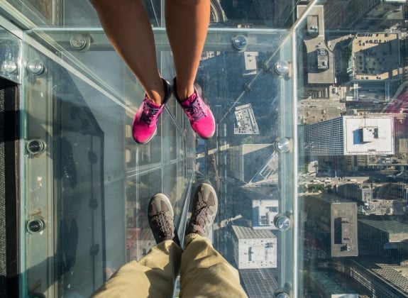 people looking down through the sky deck in Chicago, IL