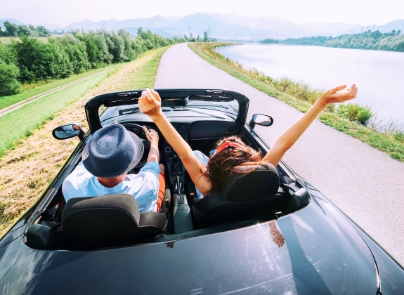 Couple ride in convertible car