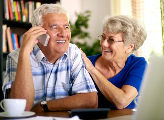 a retired couple on the phone booking rail travel