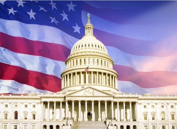 US Capitol building with an american flag in the background