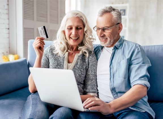 couple looking at a computer ready to book with a credit card