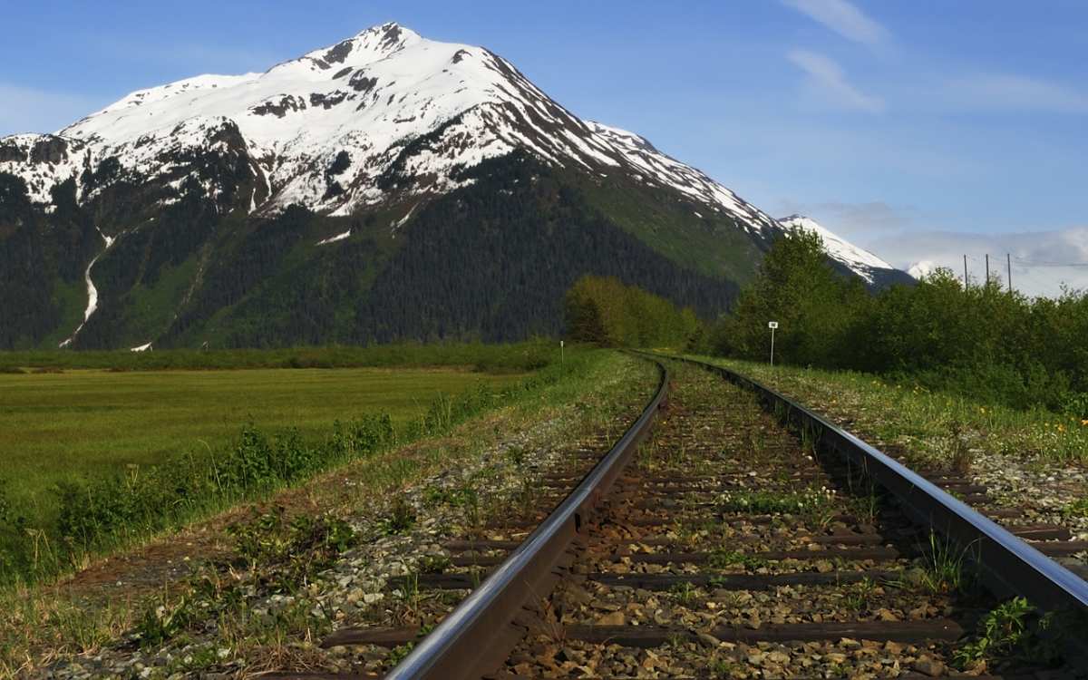 railroad tracks in Alaska by mountain view