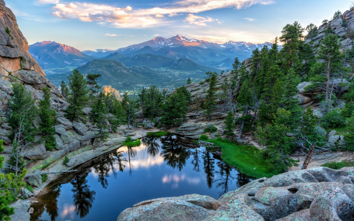 The last evening sunshine hits Longs Peak and The Crags above Gem Lake in Rocky Mountain National Park, Estes Park, Colorado