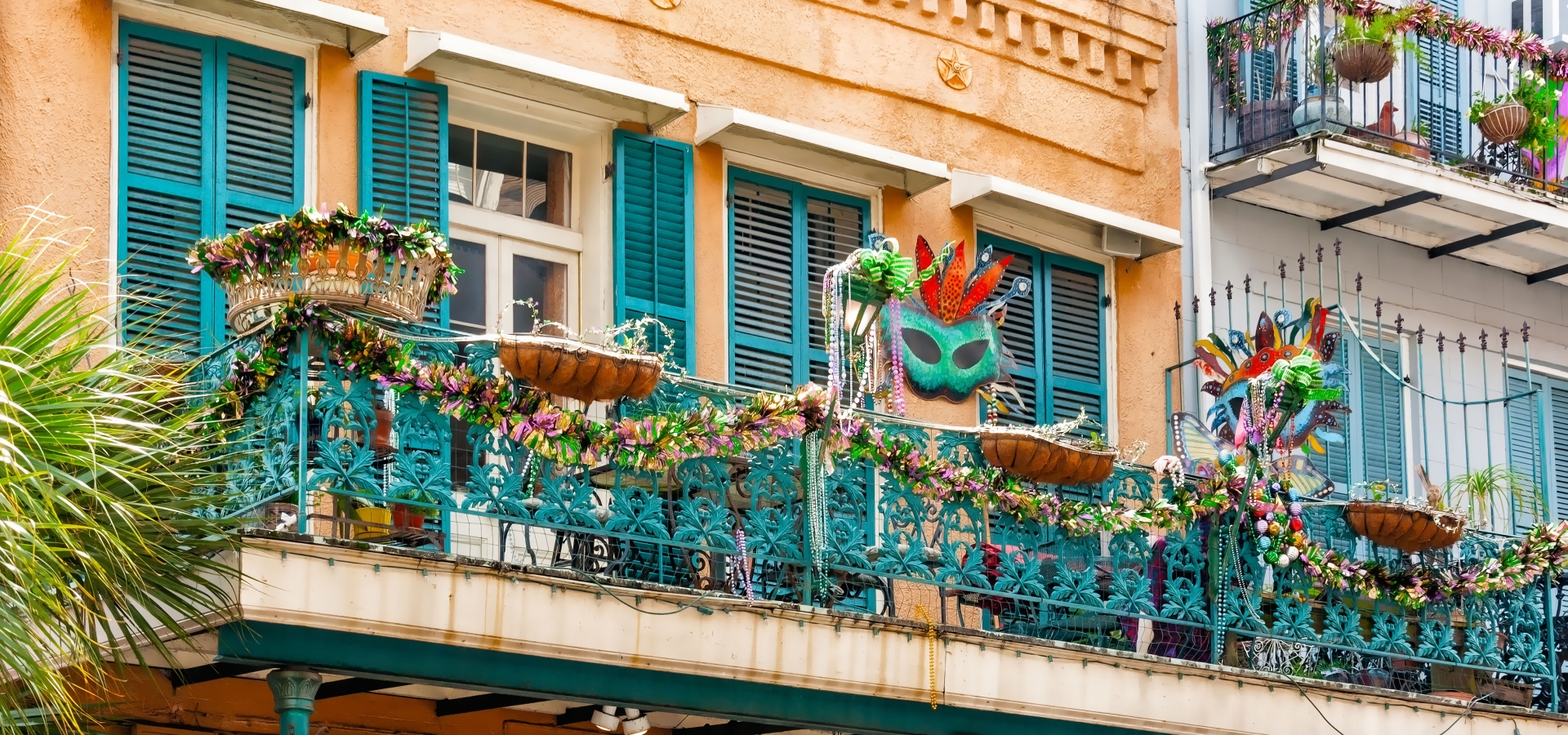 Mardi Gras Decorated Balconies. Masks, beads, garlands with Mardi Gras colors adorn these New Orleans balconies in the French Quarter.