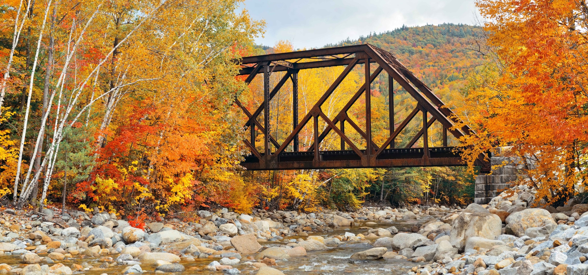 Railway bridge in woods with colorful foliage, White Mountain, NH