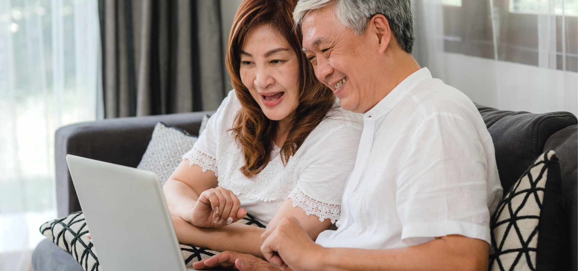 happy couple watching amtrak vacations webinar