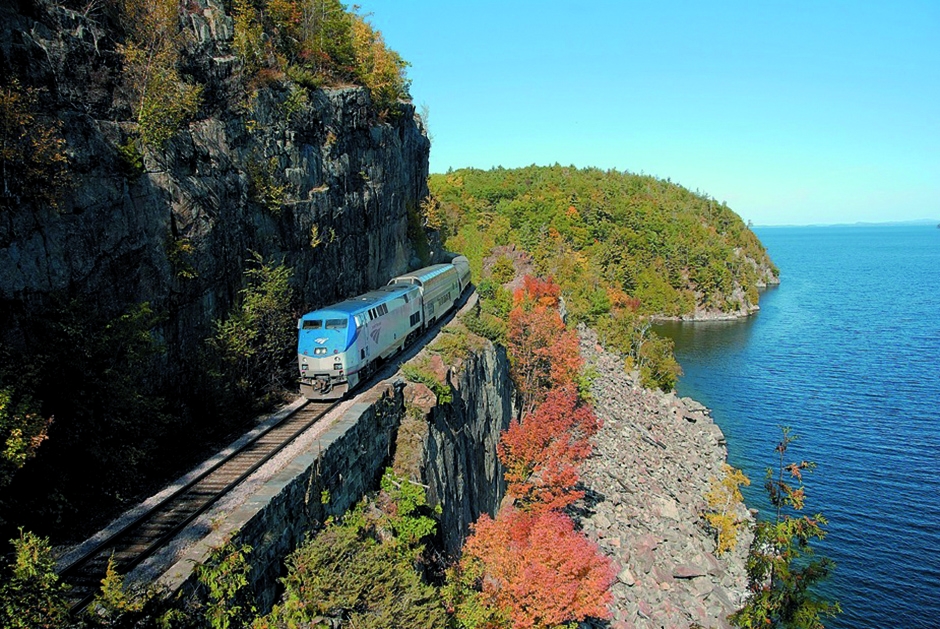 Amtrak train through fall foliage 
