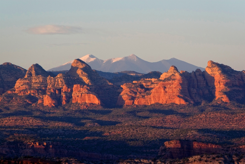 The highest mountains in Arizona, the San Francisco Peaks outside of Flagstaff can be seen through the "canines" of Sycamore Canyon as seen from Perkinsville road, about 10 miles from Jerome.