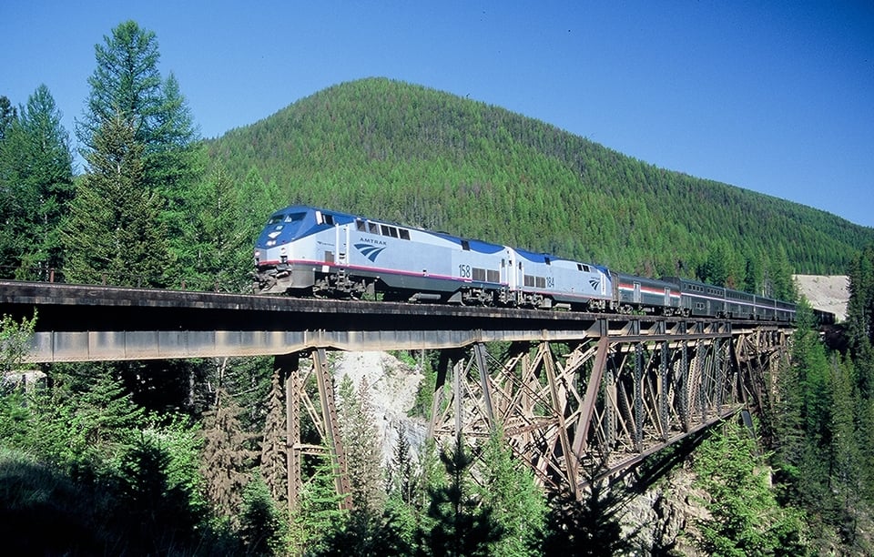 empire builder_on bridge through pine forest_Small